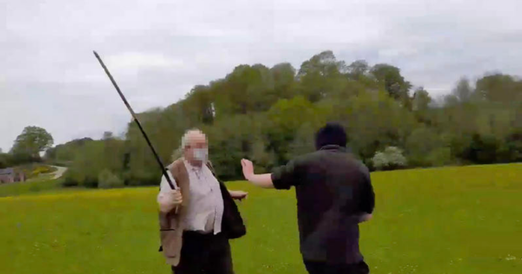 Hunt supporter threatens protester with pole