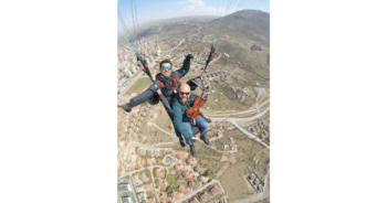 Nervous Teacher Plays Violin To Distract Himself During First Paragliding Flight